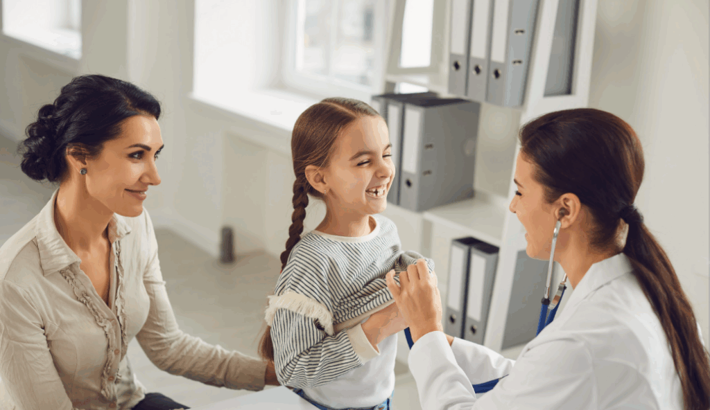 a mom and daughter meet with their pediatrician