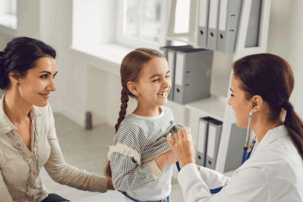a mom and daughter meet with their pediatrician