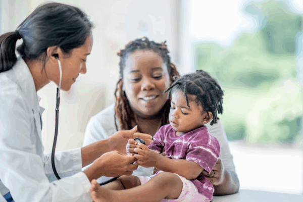 a mom and her young daughter at a family medical appointment with a pediatrician