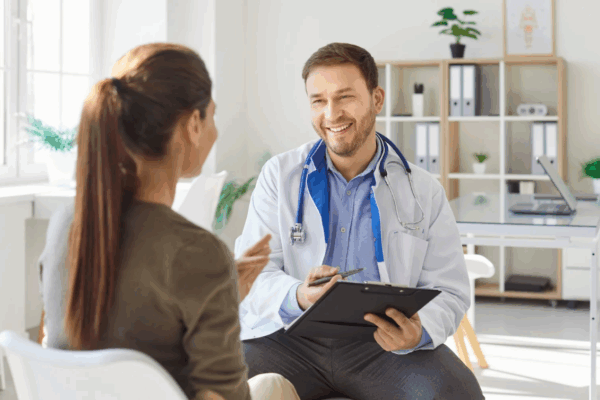 a doctor smiling at a woman during an office visit